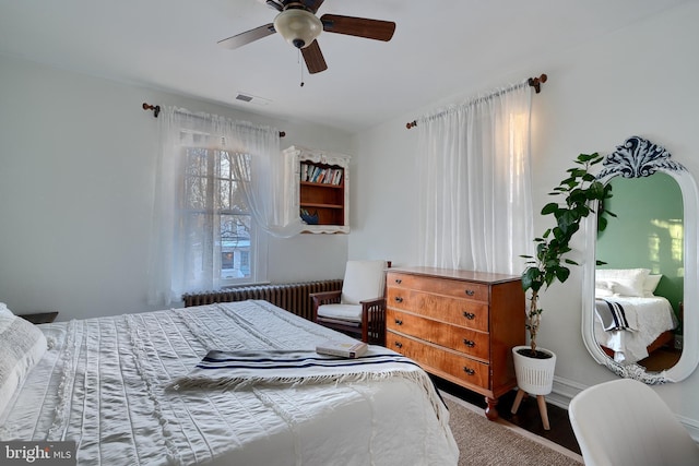 bedroom with radiator heating unit and ceiling fan