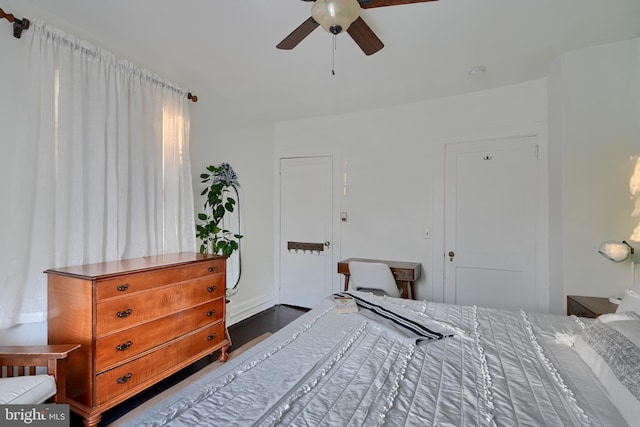 bedroom with dark wood-type flooring and ceiling fan