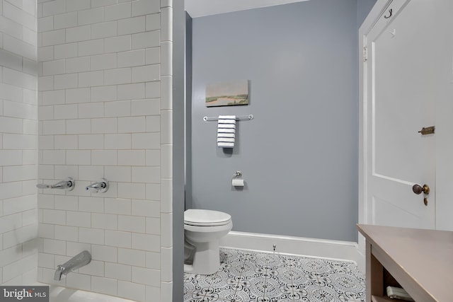 full bathroom with tiled shower / bath, tile patterned floors, toilet, and vanity