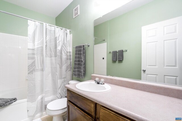 full bathroom with vanity, toilet, and shower / tub combo