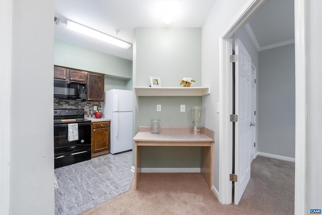 kitchen featuring tasteful backsplash, crown molding, light colored carpet, and black appliances