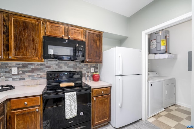 kitchen featuring washer and clothes dryer, electric water heater, decorative backsplash, and black appliances