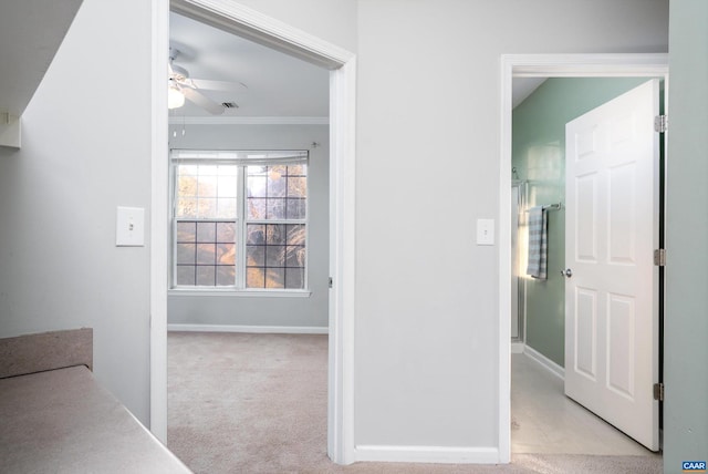 hallway with light colored carpet and ornamental molding