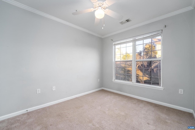 empty room featuring ornamental molding, carpet, and ceiling fan