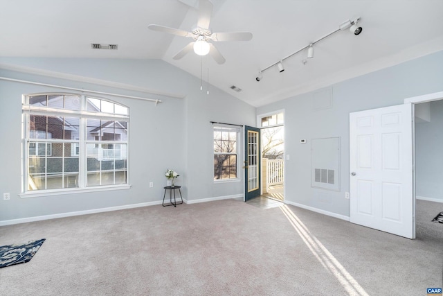 carpeted spare room featuring rail lighting, lofted ceiling, and ceiling fan