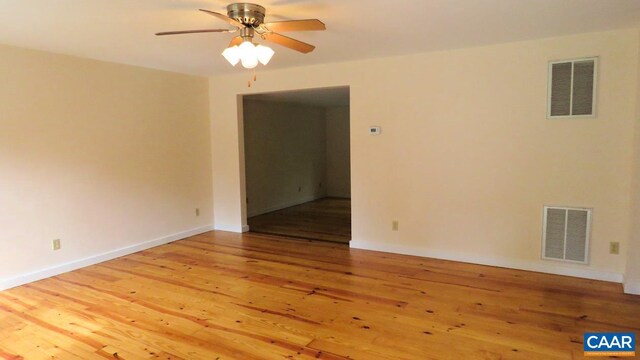 empty room with hardwood / wood-style floors and ceiling fan