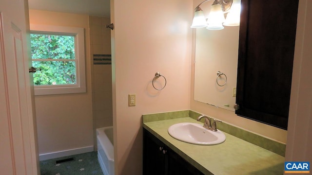 bathroom with vanity and tiled shower / bath combo