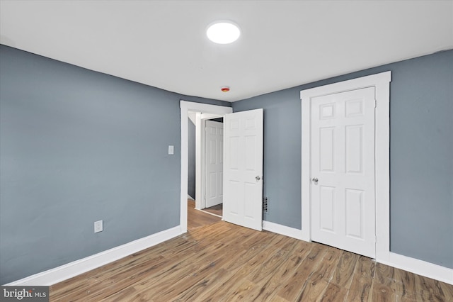 unfurnished bedroom featuring wood-type flooring