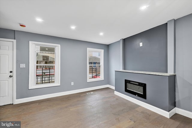 unfurnished living room with hardwood / wood-style floors