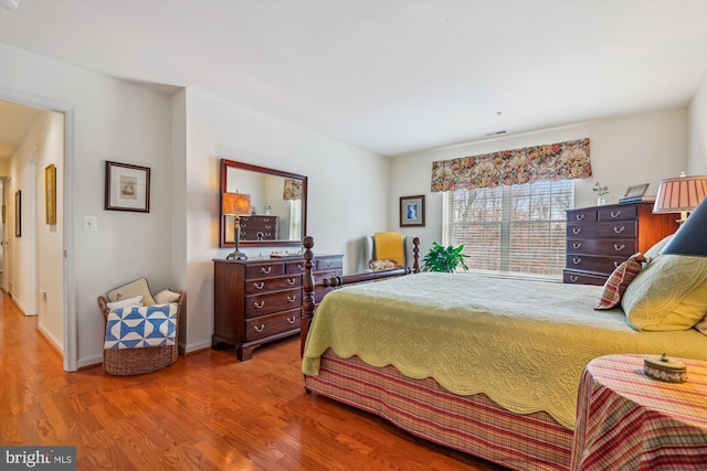 bedroom with wood-type flooring