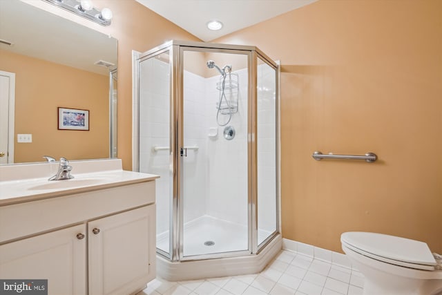 bathroom with an enclosed shower, vanity, tile patterned floors, and toilet