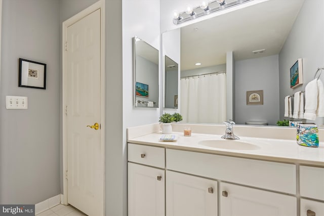 bathroom featuring vanity, tile patterned floors, and toilet