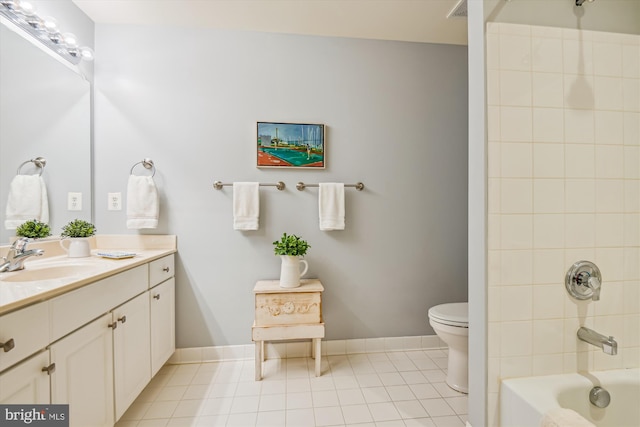 full bathroom featuring vanity, tile patterned floors, toilet, and tiled shower / bath