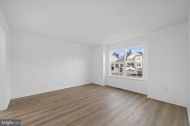 spare room featuring hardwood / wood-style floors