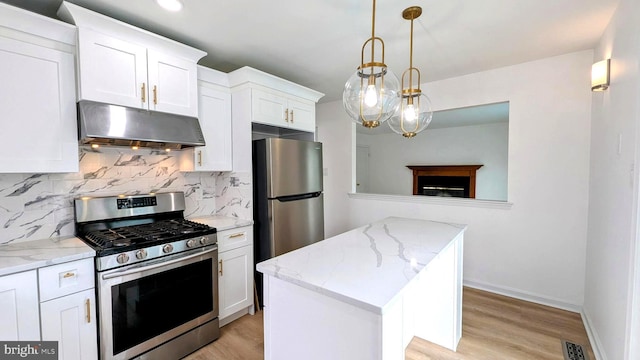 kitchen with white cabinetry, appliances with stainless steel finishes, a center island, and hanging light fixtures