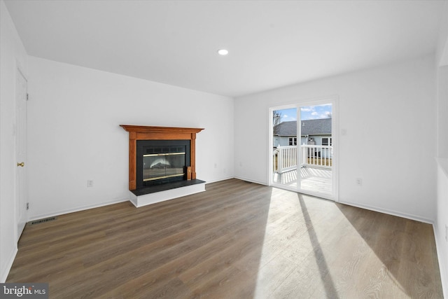 unfurnished living room with dark hardwood / wood-style flooring