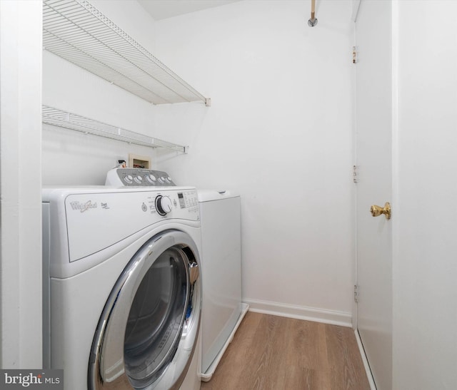 washroom featuring hardwood / wood-style flooring and independent washer and dryer