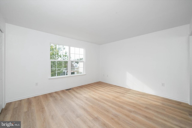 spare room with light hardwood / wood-style floors