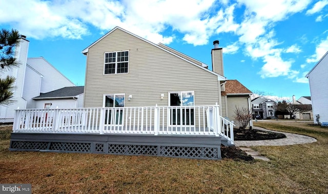 back of house with a yard and a deck