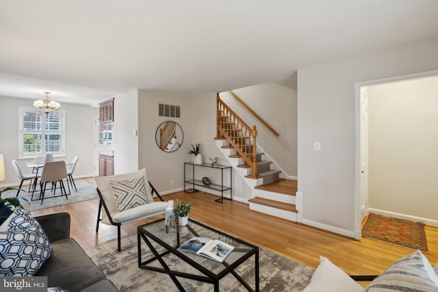 living room featuring hardwood / wood-style floors and a notable chandelier