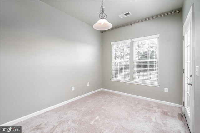 unfurnished room featuring light carpet