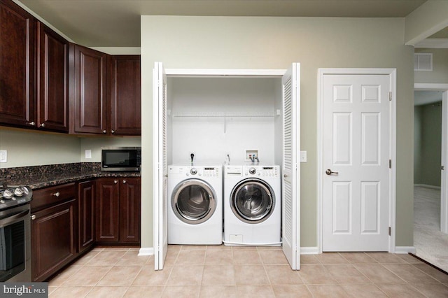 washroom featuring light tile patterned floors and washer and dryer