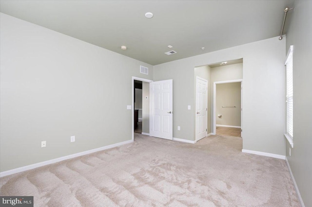 unfurnished bedroom with light colored carpet