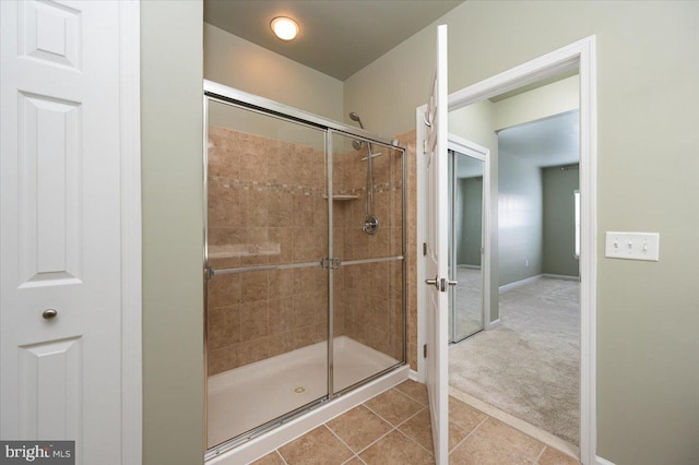 bathroom featuring tile patterned floors and a shower with door