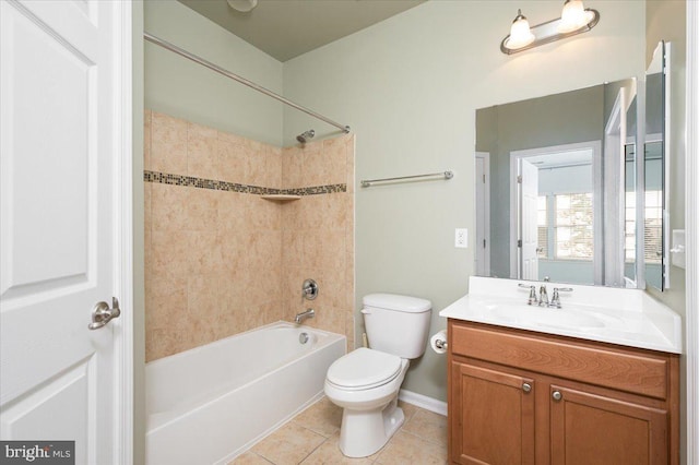 full bathroom with tiled shower / bath combo, vanity, tile patterned floors, and toilet