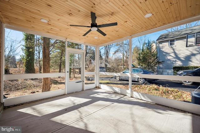 unfurnished sunroom featuring wood ceiling and ceiling fan