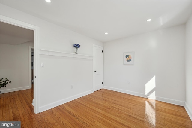 unfurnished room featuring recessed lighting, baseboards, and wood finished floors