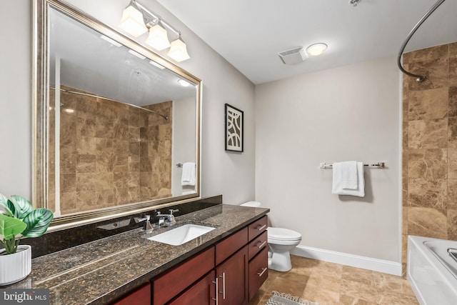 full bathroom with tiled shower / bath, vanity, and toilet