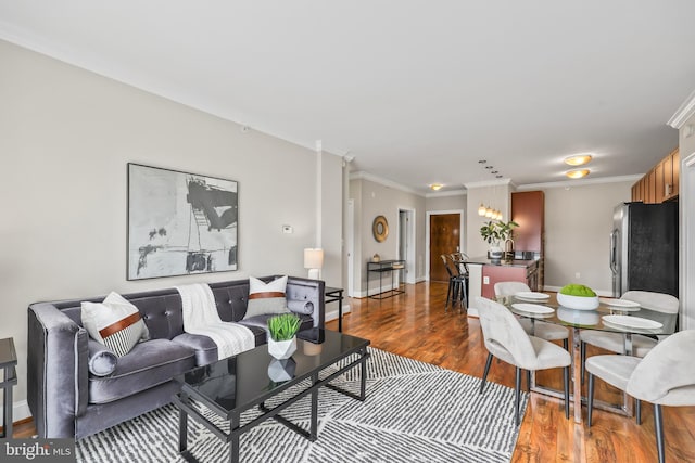 living room featuring crown molding and hardwood / wood-style floors