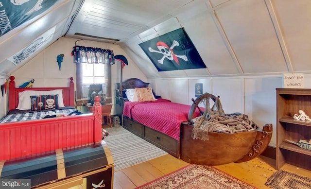 bedroom with lofted ceiling and hardwood / wood-style floors