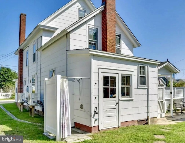 rear view of house featuring a lawn