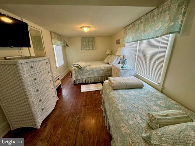 bedroom with dark hardwood / wood-style floors