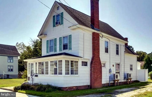 view of home's exterior with a sunroom