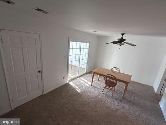 unfurnished office featuring ceiling fan and carpet flooring