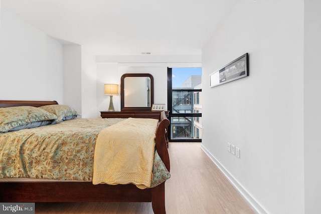 bedroom with hardwood / wood-style flooring