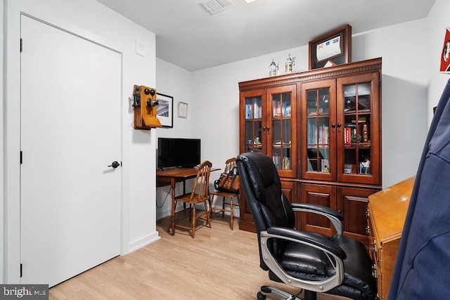 home office with light hardwood / wood-style floors