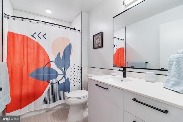 bathroom with vanity, toilet, and walk in shower