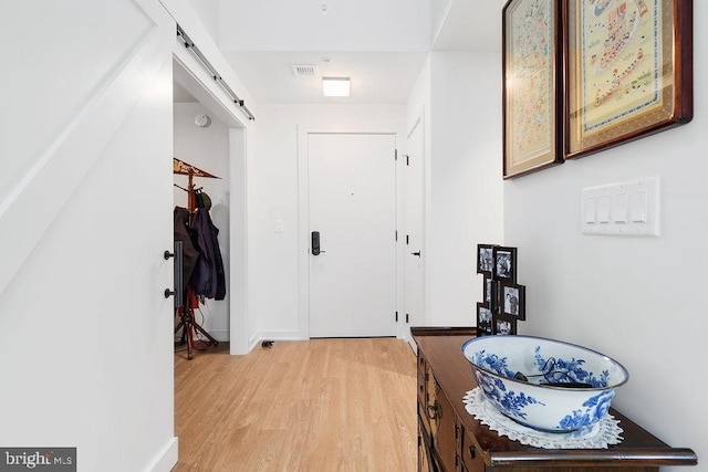 interior space featuring light hardwood / wood-style flooring and a barn door