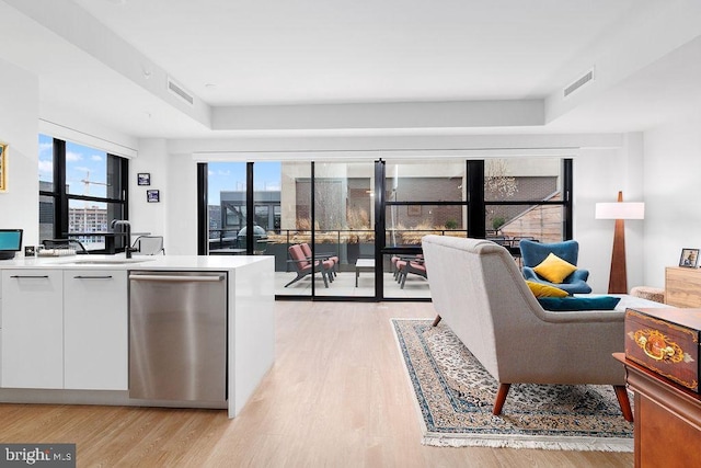 living room with sink and light hardwood / wood-style floors