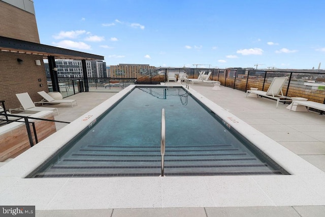 view of swimming pool with a patio