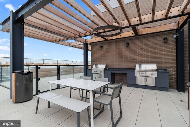 view of patio / terrace with area for grilling, a pergola, and grilling area