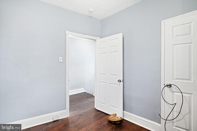 empty room with dark hardwood / wood-style floors