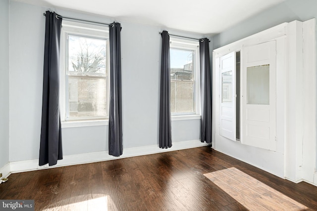 unfurnished room with hardwood / wood-style floors and a wealth of natural light