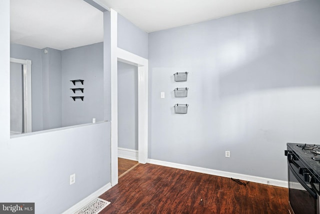 corridor featuring dark wood-type flooring