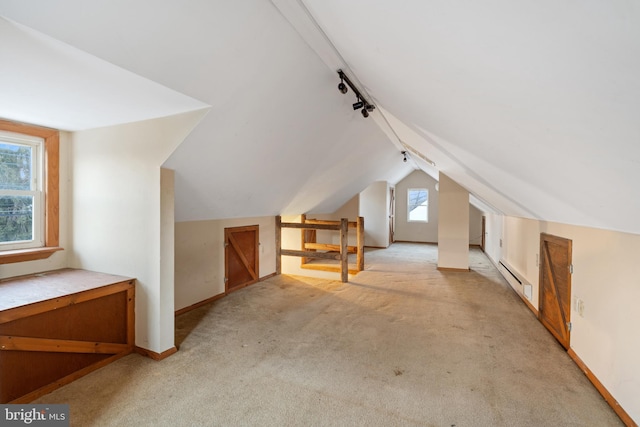 bonus room featuring light carpet, a baseboard radiator, and lofted ceiling