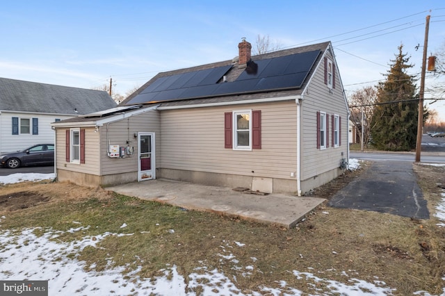 exterior space with a patio and solar panels